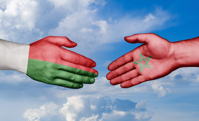 Morocco and Madagascar country handshaking with flags, consensus concept international co-operation illustration