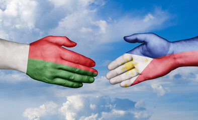 Philippines and Madagascar country handshaking with flags, consensus concept international co-operation illustration