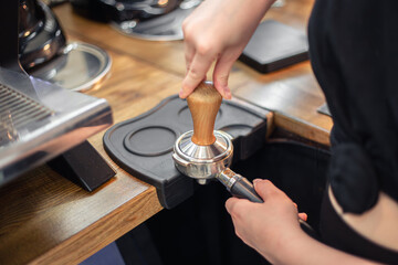 Close-up of hand Barista cafe making coffee. Barista with coffee.