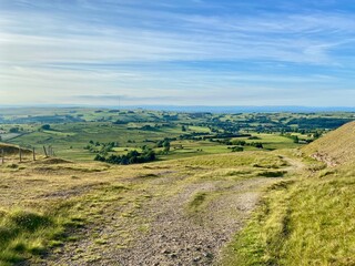 Scenic countryside path winding across grassy hills with panoramic rural views