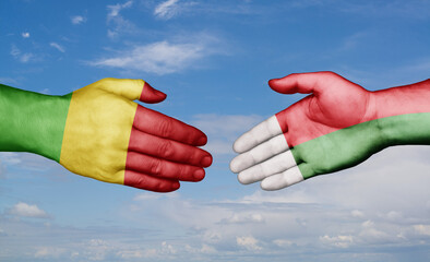 Madagascar and Mali country handshaking with flags, consensus concept international co-operation illustration