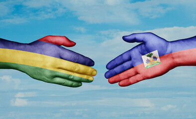 Haiti and Mauritius country handshaking with flags, consensus concept international co-operation illustration