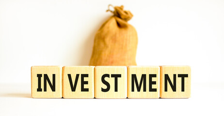 Investment symbol. Concept word Investment on beautiful wooden blocks. Beautiful white background. Beautiful canvas bag. Business investment concept. Copy space.
