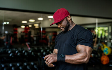 Man preparing for workout in modern gym facility.