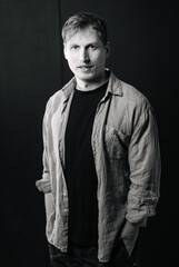 Casual male portrait on dark background.