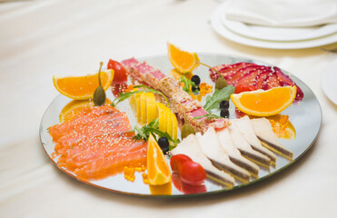 Colorful seafood platter with citrus and garnishes.