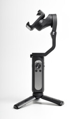 Gimbal stabilizer for Smartphone isolated on white background. Modern stabilizer-gimbal for photo-video shooting. Gadgets for blogging, streaming, video and videography