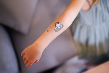 Unicorn tattoo on a child's hand