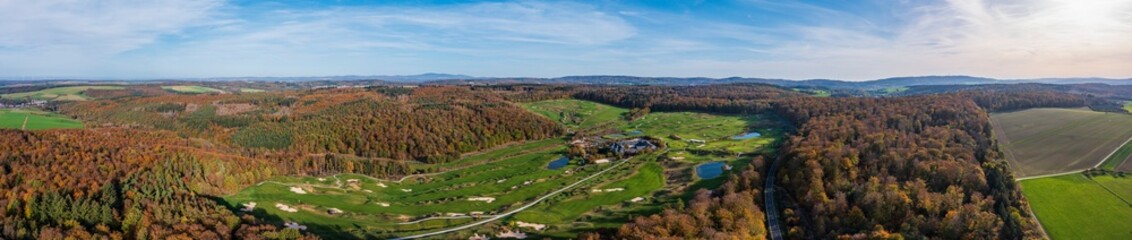 Obraz premium Aerial view of the autumnally colored forest in the Taunus on a sunny day
