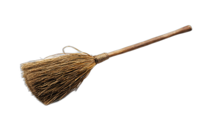 A witches broom with straw bristles and a wooden handle isolated on a plain white background