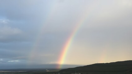 Rainbow Over Hills and Clouds