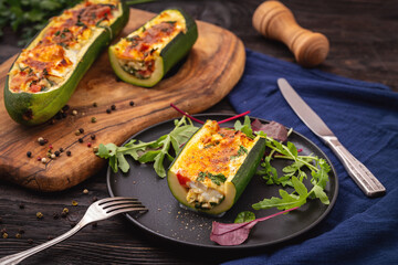 Zucchini stuffed with feta cheese, egg, parsley and cherry tomatoes