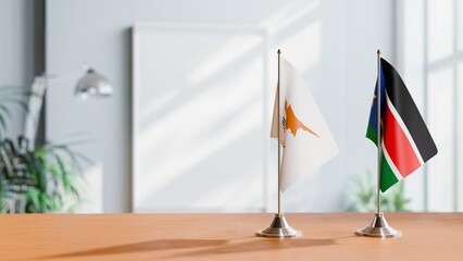FLAGS OF CYPRUS AND SOUTH SUDAN ON TABLE