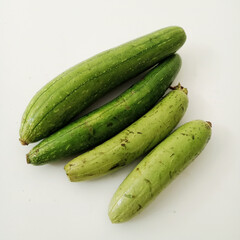 Sponge gourds isolated on a white background. Closeup on Luffa. loofa.