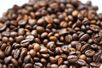 Scattered coffee beans on white background