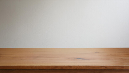 Wooden countertop with a white wall background, perfect for showcasing products.