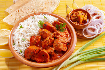 Chicken Tikka with jeera rice with papadum and mango pickle and sliced onion   
