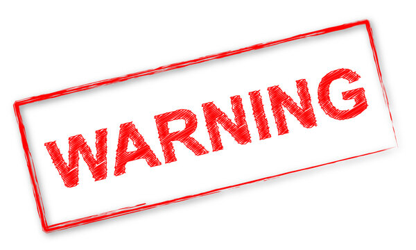 Timbre rouge avec le mot "Warning"