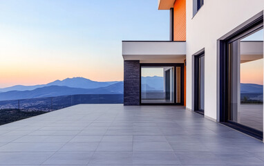 Modern architectural design with panoramic mountain views at sunset from a stylish terrace