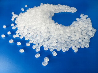 virgin raw material granules, white plastic resin material granules hot cut type, isolated on blue background, for plastic industry profile product catalog design