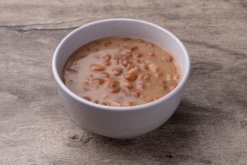 Cooked brown beans in a bowl over wooden table