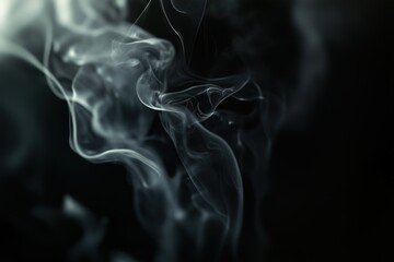 A black and white photo of smoke with a dark background