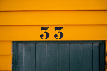 colorful beach huts closeup on the beach number 33 sign