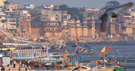 Varanasi, Uttar Pradesh, India. Many Boats are moored to the Ganga riverbank. Tourists boarding for...