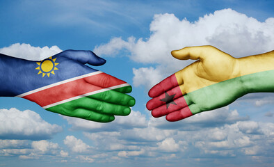 Guinea-Bissau and Namibia country handshaking with flags, consensus concept international co-operation illustration