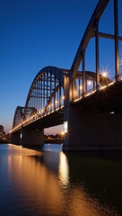Obraz premium Sleek steel arches of Hoan Bridge illuminate at dusk over the Milwaukee River with soft LED light reflections on the waters surface