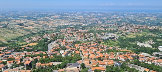 Summer view from San Marino to Italy. June 28, 2024. Italy landscape around San Marino - hills, houses, roofs, nature.