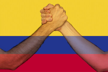 Two hands gathering front of Colombia flag, help or support for Colombia, togetherness and 