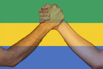 Two hands gathering front of Gabon flag, human rights, help or support for Gabon, togetherness 