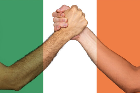 Two hands gathering front of Ireland flag, help or support for Ireland, human rights, togetherness 