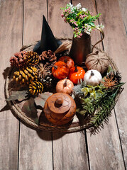 Halloween objects on a tray with a wooden background.