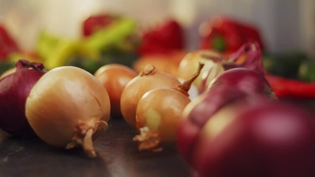 White and purple onions roll on the background of fresh vegetables. High quality FullHD footage