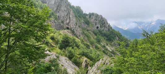 Summer view to Via dei Colli, Italy. June 27, 2024. Road with tunels though montains.