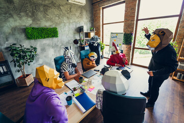 Photo of panda rooster gorilla lion sloth zebra raccoon mask business people discussion loft...