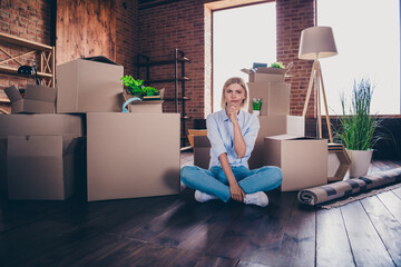 Full length photo of lovely cheerful girl sit floor skeptical minded dressed shirt jeans buy move...