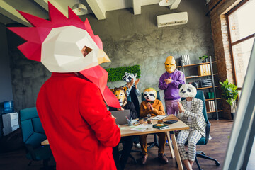 Photo of panda gorilla lion sloth zebra raccoon mask business people applaud rooster boss loft...