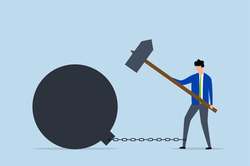 breaking bad habits for freedom, businessman confidently uses a hammer to shatter the heavy chain weighing him down.