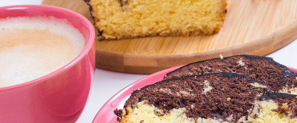 Fresh baked yeast cake with cocoa, cup of cappuccino. Delicious dessert. White background