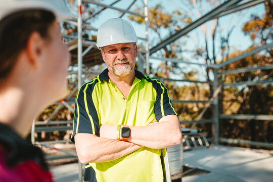 Construction workers looking and talking at the construction site.
