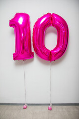 pink number 10 balloons on white background