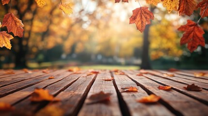 Empty wooden tabletop with a blurred background featuring autumn leaves High quality image