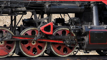 Close-up of part of an old black steam locomotive