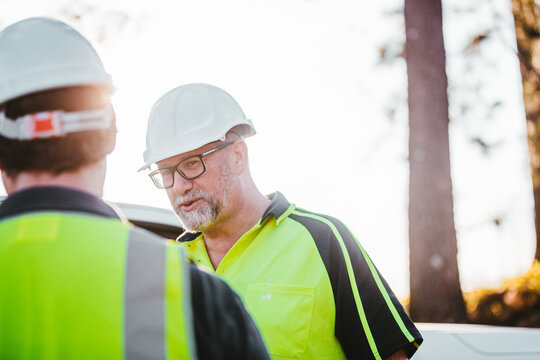 Construction workers standing at the construction site having conversation