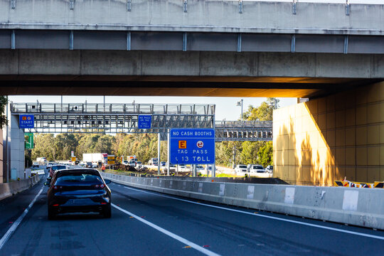 overpass before toll road toll point with no cash booth sign e-tag e-pass signage