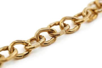 Obraz premium Close-up shot of a gold chain lying on a white surface, perfect for highlighting jewelry or accessories