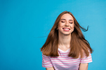 Photo portrait of adorable nice cheerful woman wear stylish striped pink clothes isolated on blue color background